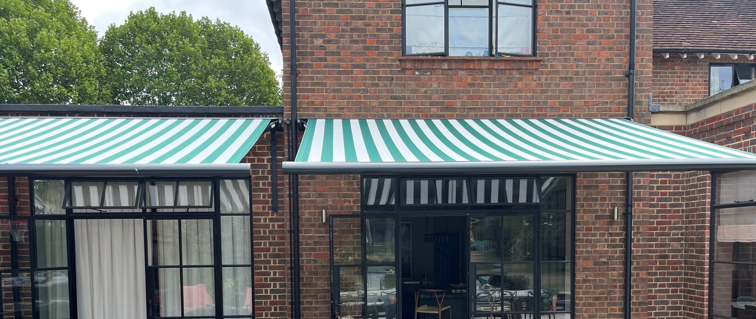 Close up of striped acrylic awning fabric stretched over an aluminium front bar